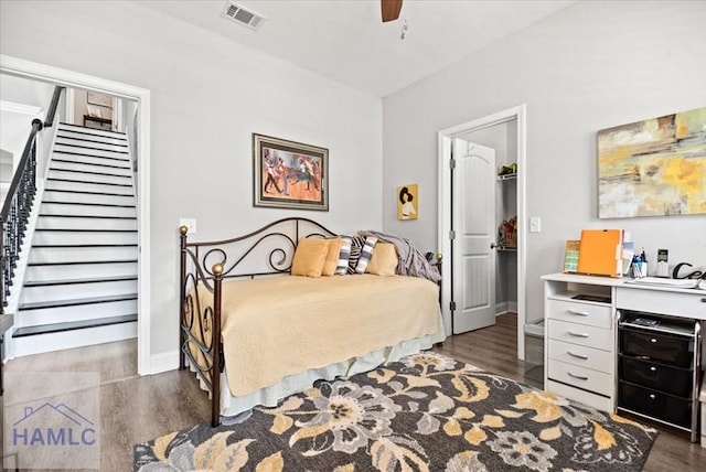 bedroom with dark hardwood / wood-style floors and ceiling fan