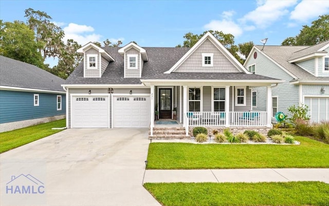 view of front facade featuring a front lawn, covered porch, and a garage