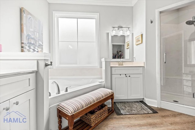 bathroom featuring separate shower and tub, hardwood / wood-style floors, vanity, and ornamental molding