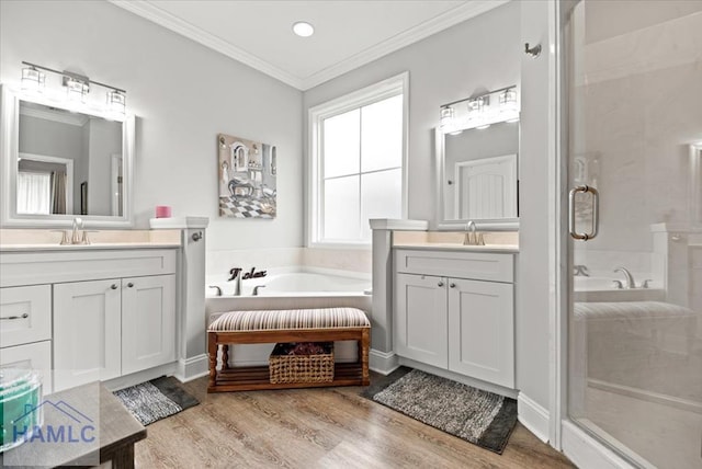 bathroom with crown molding, plus walk in shower, vanity, and hardwood / wood-style flooring