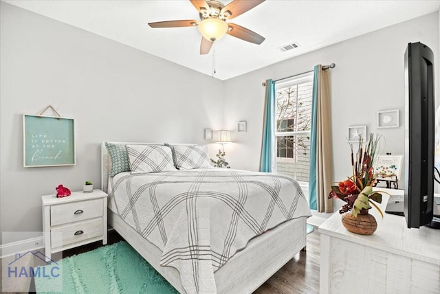 bedroom with ceiling fan and dark wood-type flooring