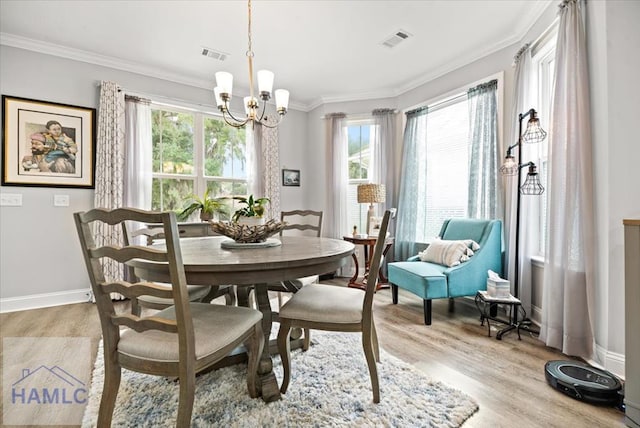 dining room featuring light hardwood / wood-style floors, an inviting chandelier, and plenty of natural light