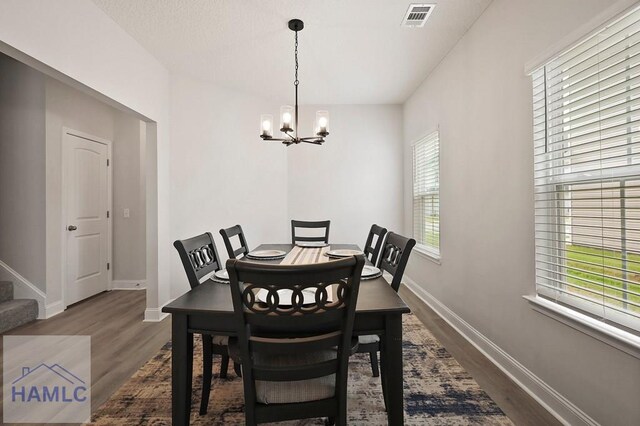 1201 Grayson Ave, Hinesville, GA 31313 - dining space featuring a chandelier, dark wood-style floors, baseboards, and stairway