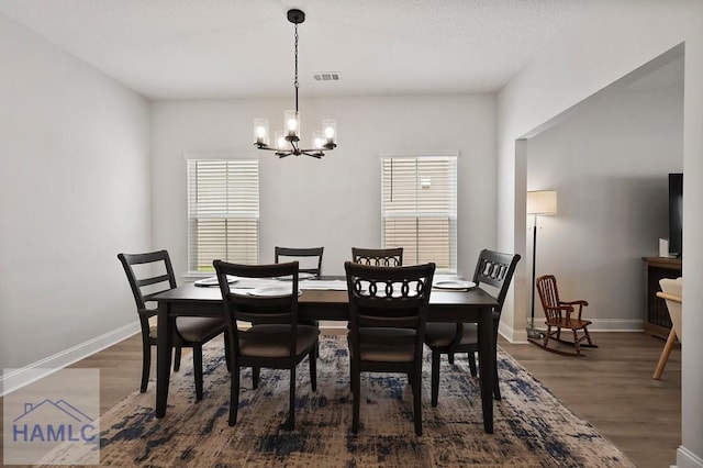 1201 Grayson Ave, Hinesville, GA 31313 - dining area with a chandelier, plenty of natural light, wood finished floors, and baseboards