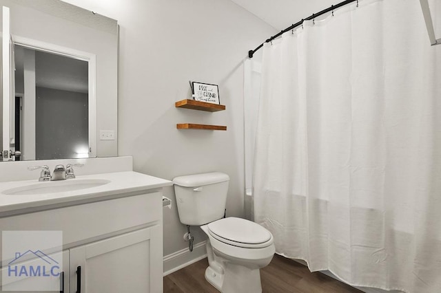 1201 Grayson Ave, Hinesville, GA 31313 - bathroom featuring wood finished floors, toilet, vanity, baseboards, and a shower with shower curtain