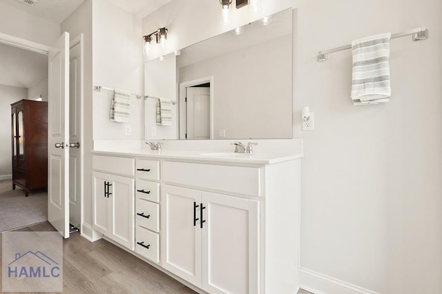 1201 Grayson Ave, Hinesville, GA 31313 - full bath featuring double vanity, wood finished floors, and baseboards