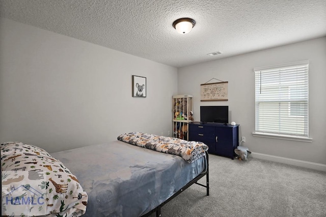 1201 Grayson Ave, Hinesville, GA 31313 - bedroom with light carpet, a textured ceiling, and baseboards