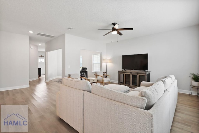 1201 Grayson Ave, Hinesville, GA 31313 - living room featuring a ceiling fan, wood finished floors, baseboards, recessed lighting, and a textured ceiling