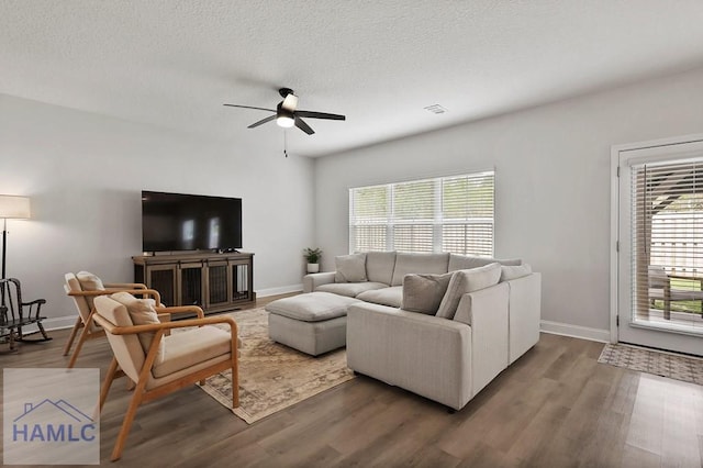 1201 Grayson Ave, Hinesville, GA 31313 - living area featuring a ceiling fan, wood finished floors, baseboards, and a textured ceiling