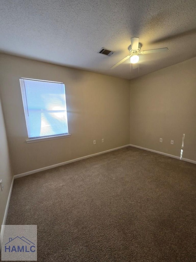 empty room featuring a textured ceiling, ceiling fan, and carpet flooring