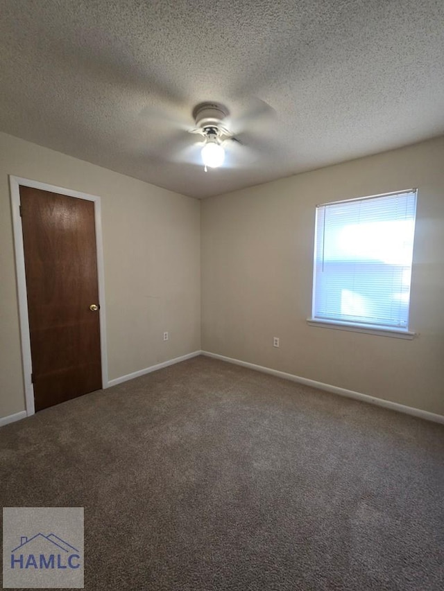 carpeted empty room featuring a textured ceiling and ceiling fan