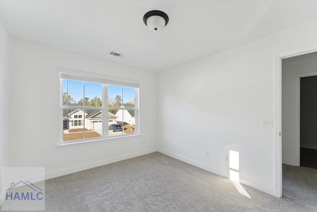 unfurnished room featuring carpet floors, baseboards, and visible vents