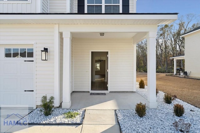 property entrance with board and batten siding and an attached garage