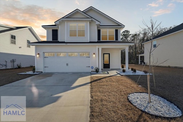 view of front of property with board and batten siding, concrete driveway, covered porch, and an attached garage