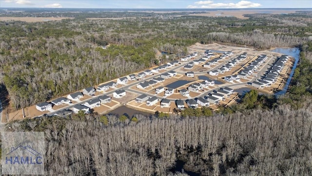 drone / aerial view featuring a forest view