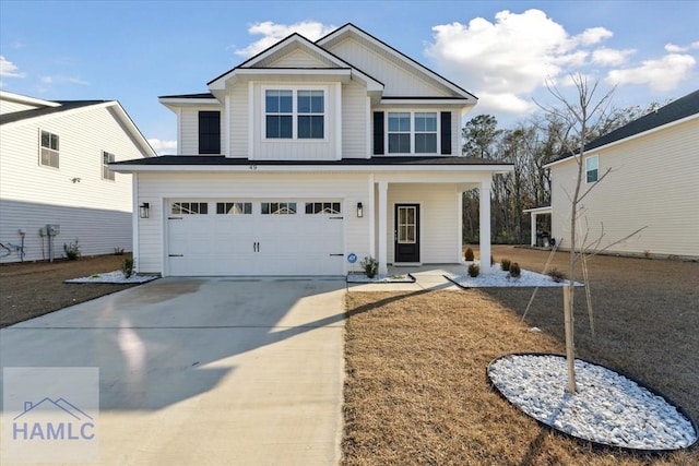 view of front of property with driveway, an attached garage, a porch, and board and batten siding