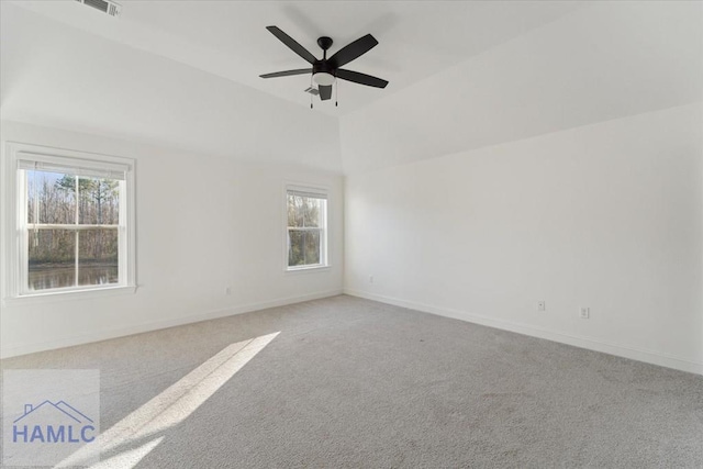 spare room with baseboards, ceiling fan, visible vents, and light colored carpet