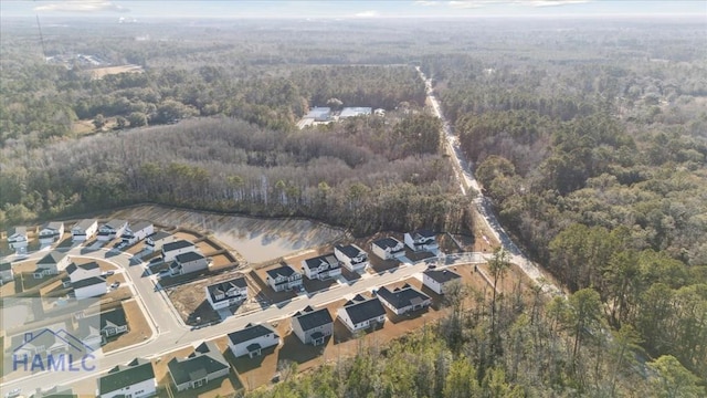 aerial view featuring a wooded view and a residential view