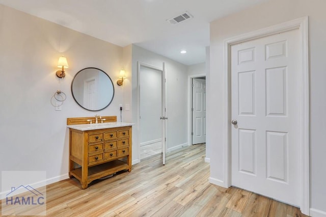 bathroom with wood-type flooring and vanity