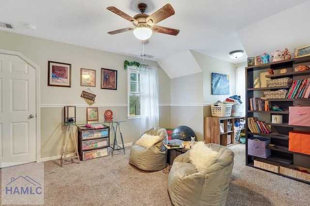 living area with carpet flooring, vaulted ceiling, and ceiling fan