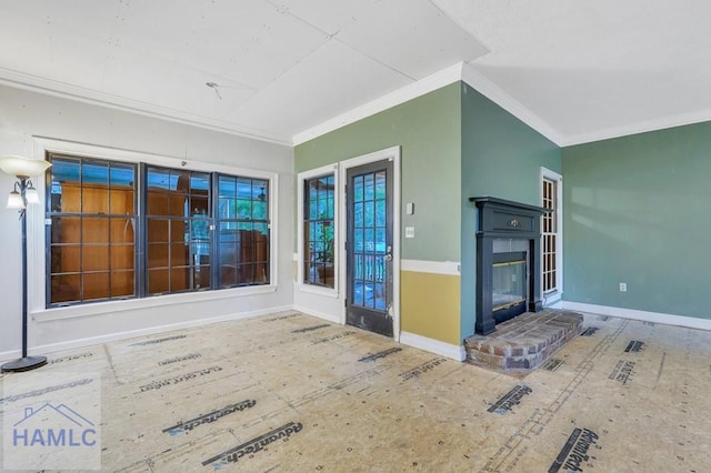 unfurnished living room with crown molding and a brick fireplace