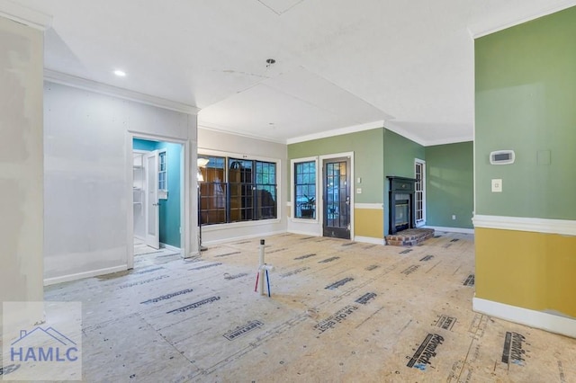 unfurnished living room with crown molding