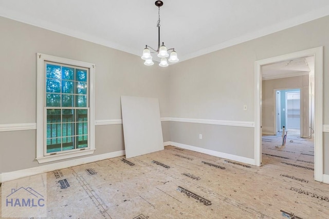 spare room featuring hardwood / wood-style flooring, a notable chandelier, and crown molding