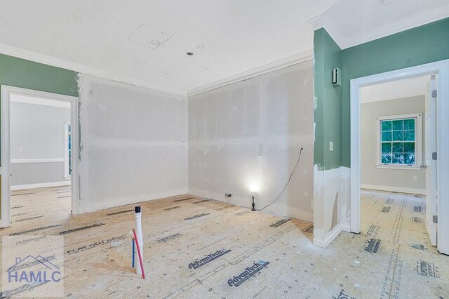 empty room featuring ornamental molding