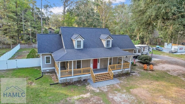 view of front of property with covered porch and a front yard