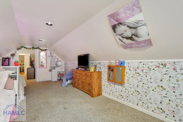 carpeted bedroom with lofted ceiling