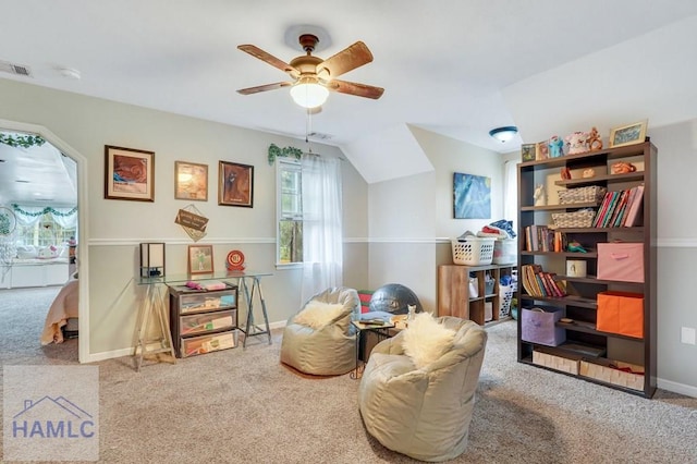 sitting room with carpet, ceiling fan, and lofted ceiling