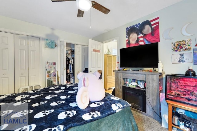 bedroom featuring ceiling fan, carpet, and two closets