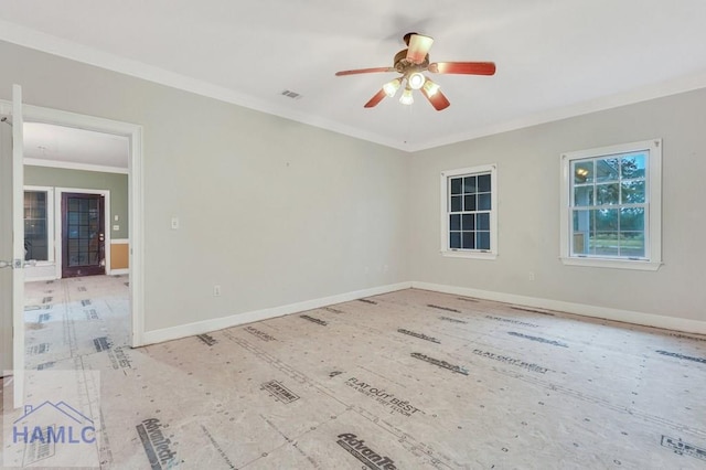 spare room featuring ceiling fan and crown molding