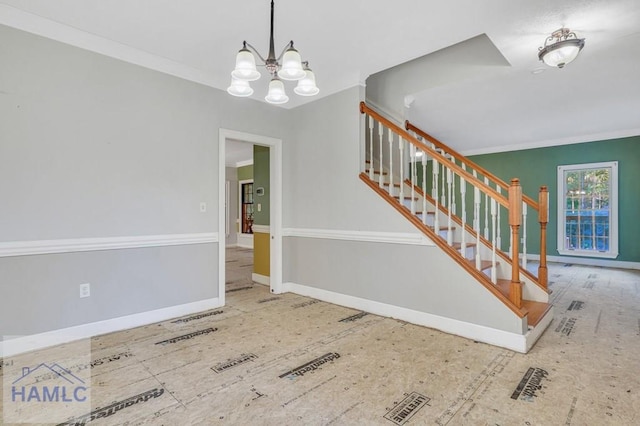 interior space featuring crown molding and a notable chandelier