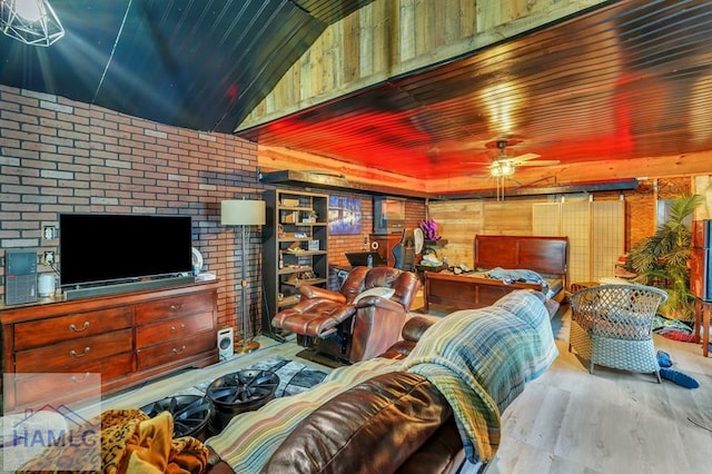 living room featuring wood ceiling, light hardwood / wood-style flooring, ceiling fan, and brick wall