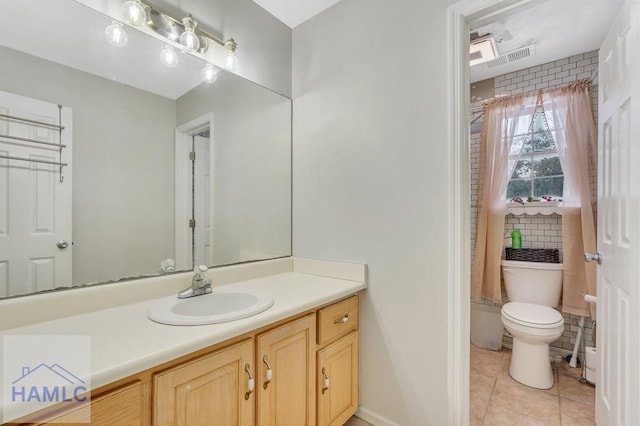 bathroom featuring tile patterned flooring, vanity, and toilet