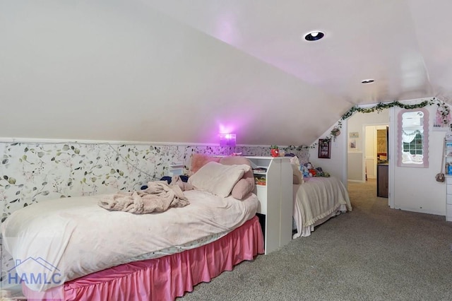 carpeted bedroom with lofted ceiling