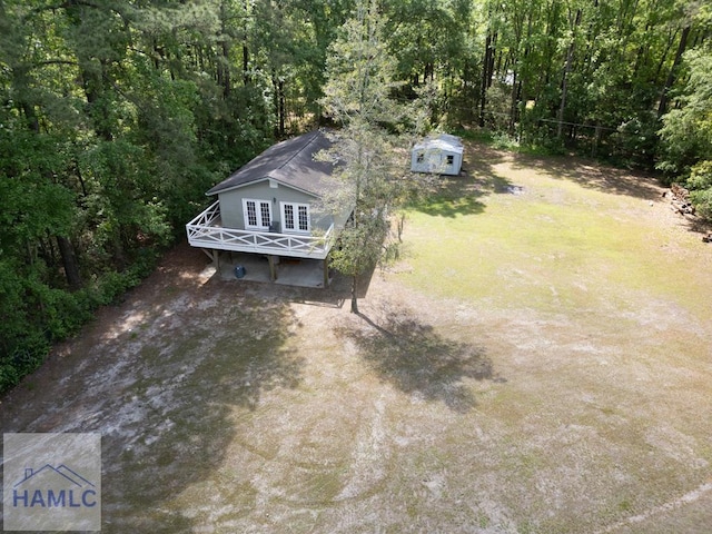 drone / aerial view featuring a wooded view