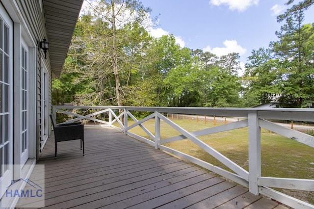 wooden terrace with a lawn