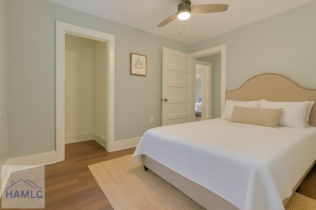 bedroom featuring dark wood-type flooring, a ceiling fan, and baseboards