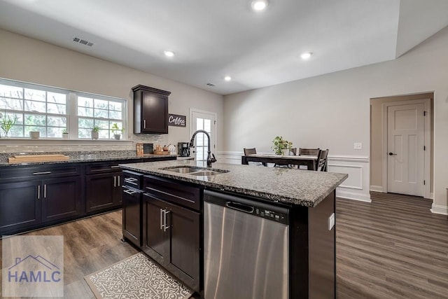 kitchen with a sink, visible vents, dark wood-style flooring, and stainless steel dishwasher