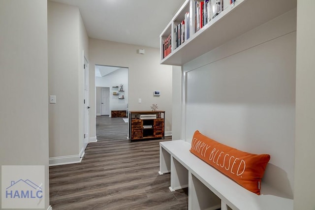 mudroom featuring dark wood-type flooring and baseboards