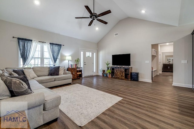 living area with high vaulted ceiling, a ceiling fan, visible vents, baseboards, and dark wood-style floors