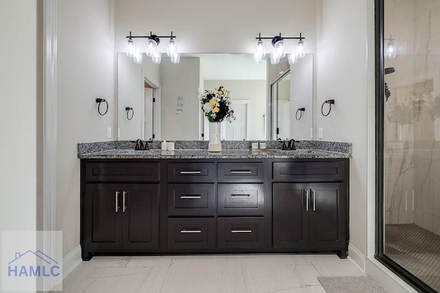 bathroom featuring marble finish floor, double vanity, a sink, a shower stall, and baseboards