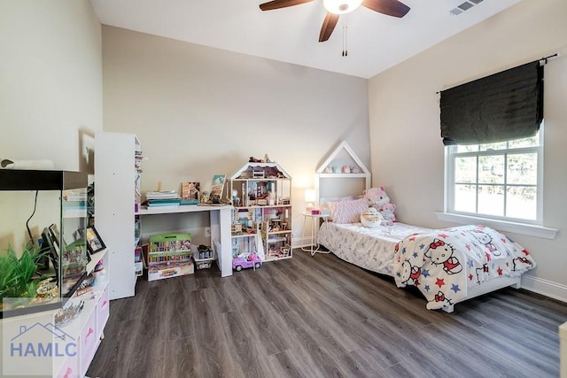 bedroom featuring baseboards, visible vents, ceiling fan, and wood finished floors