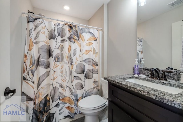 full bath with a shower with shower curtain, visible vents, vanity, and toilet