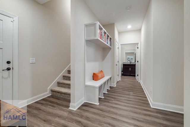 mudroom featuring baseboards and wood finished floors