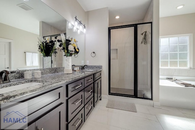 full bath with a garden tub, double vanity, a stall shower, and a sink