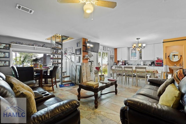 132 River Rd, Midway, GA 31320 - living area with a chandelier and ceiling fan