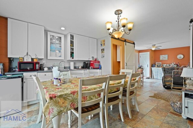 132 River Rd, Midway, GA 31320 - dining area with a barn door, stone tile floors, a ceiling fan, a chandelier, and recessed lighting